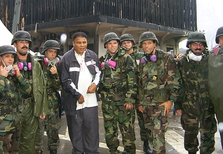 Color photo of Muhammad Ali with soldiers at Ground Zero one week after 9/11.