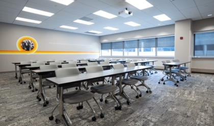 Empty classroom at the Muhammad Ali Center with desks and chairs in rows