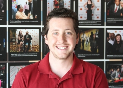 Man in a red shirt smiling