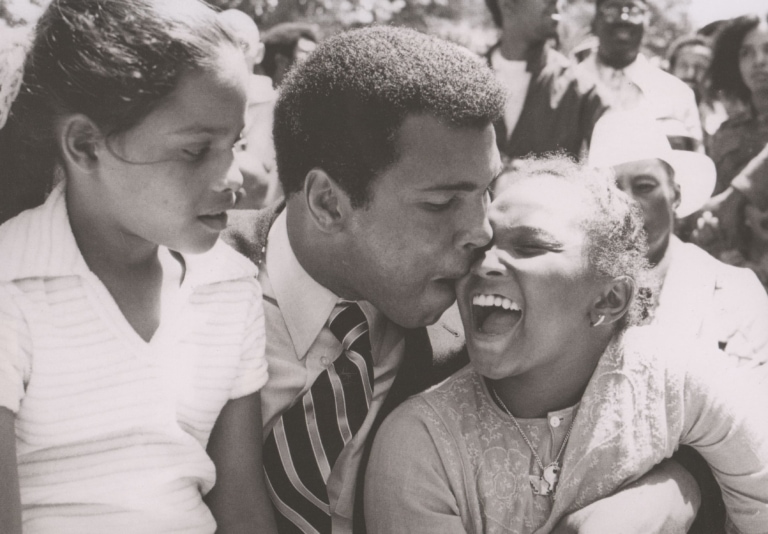 Black and white photo of Muhammad ALi with his daughters, Rasheeda and Maryum