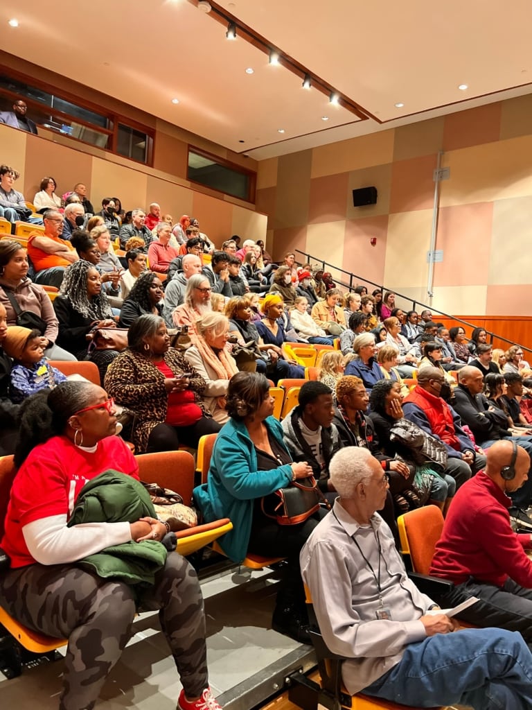 An auditorium at the Ali Center full of mostly adults and a few teens and children