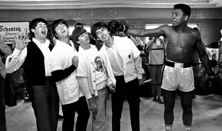 Black and white photo of Muhammad Ali and the members of the Beatles