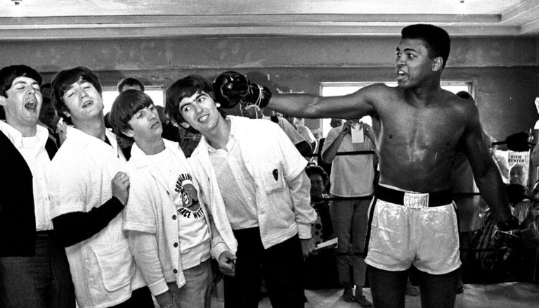 Black and white photo of Muhammad Ali and the members of the Beatles